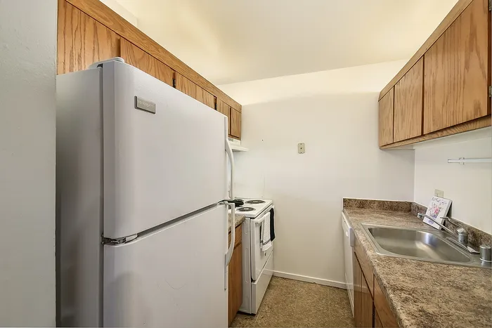 Cozy and efficient kitchen with modern appliances and ample storage, perfect for culinary enthusiasts.