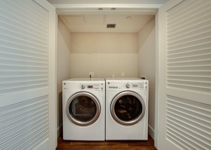 Modern laundry nook with sleek washer and dryer set in a stylish apartment, highlighting convenience and efficiency.