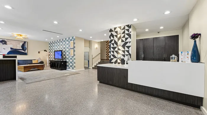 Chic and modern lobby with stunning geometric wall accents, sophisticated seating area, and elegant reception desk.