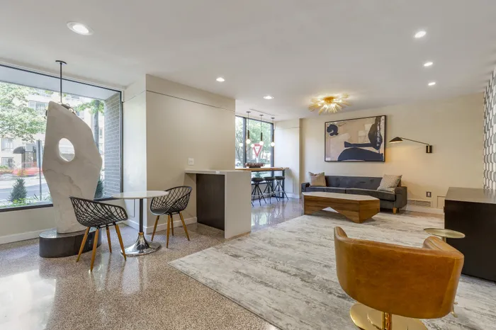 Contemporary apartment lounge with luxurious decor, featuring modern furnishings, elegant lighting, and large windows for natural light.