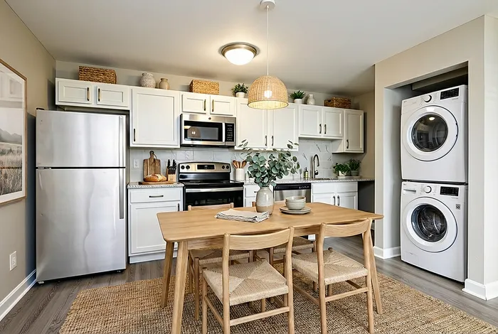 Chic kitchen with modern appliances, elegant wood dining table, and convenient in-unit laundry, featuring stylish decor and ample storage.