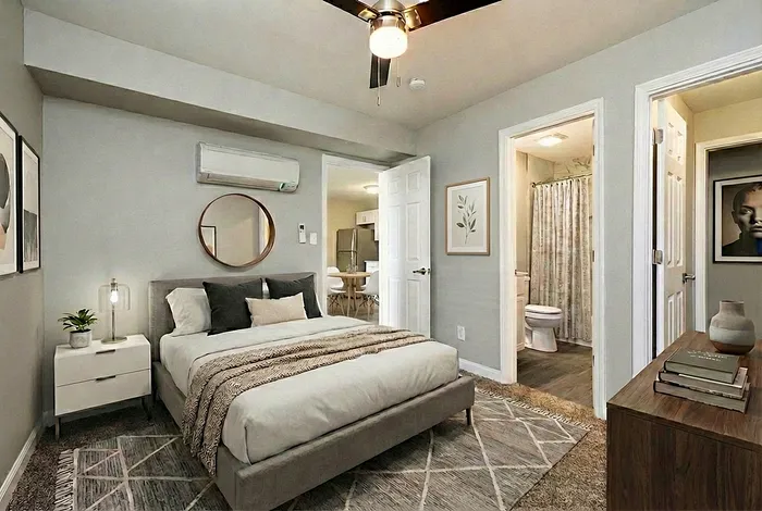Cozy bedroom featuring modern decor, plush bedding, and a stylish en-suite bathroom.
