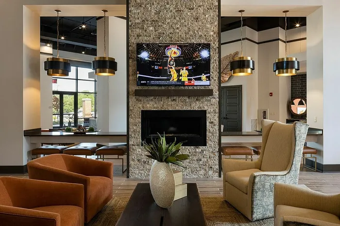 Sophisticated living area with modern fireplace, elegant furnishings, and stylish pendant lights creating a warm ambiance.