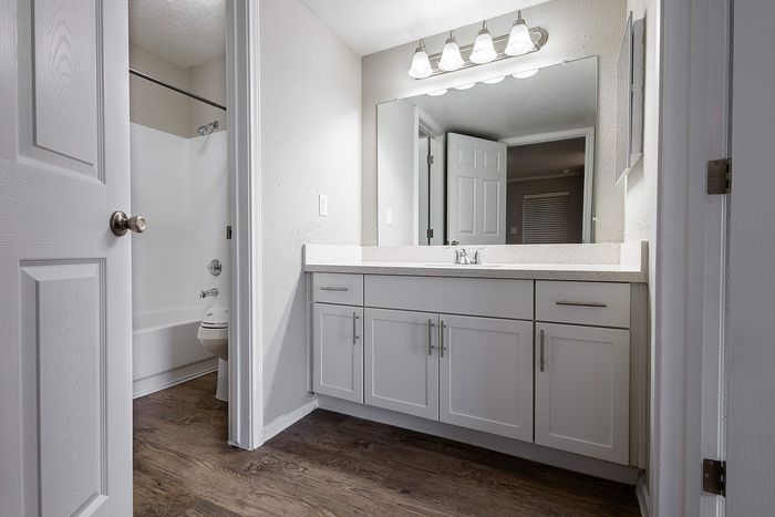 Elegant bathroom with modern fixtures, large mirror, bright lighting, and sleek cabinetry, offering a premium and comfortable experience.