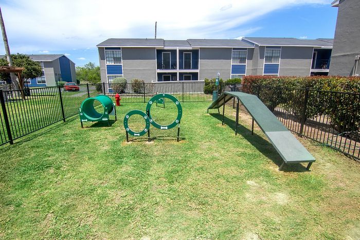 Charming pet-friendly community featuring an outdoor play area with agility equipment, perfect for active pets.