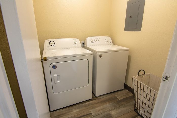 Convenient in-unit laundry room featuring modern washer and dryer, enhancing everyday living.