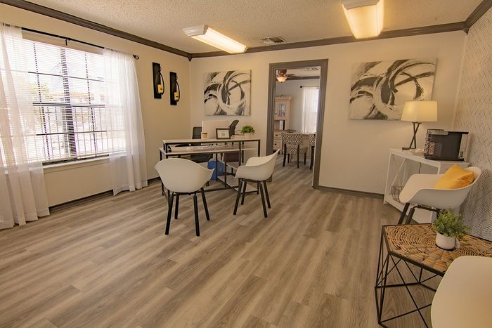 Bright and inviting living space with modern d&eacute;cor, large windows, and elegant wood flooring, perfect for comfortable living.