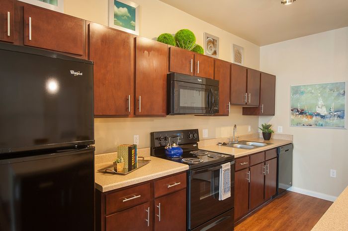 Elegant kitchen with rich wooden cabinets, modern appliances, and tasteful decor, perfect for culinary adventures.