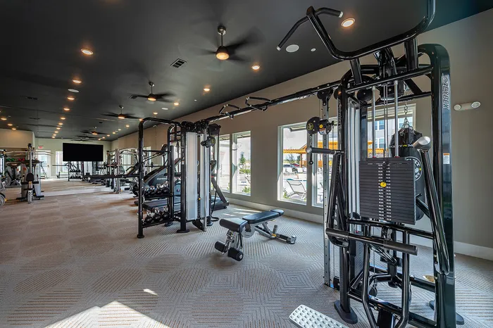 Spacious and modern fitness center featuring state-of-the-art gym equipment and plenty of natural light.