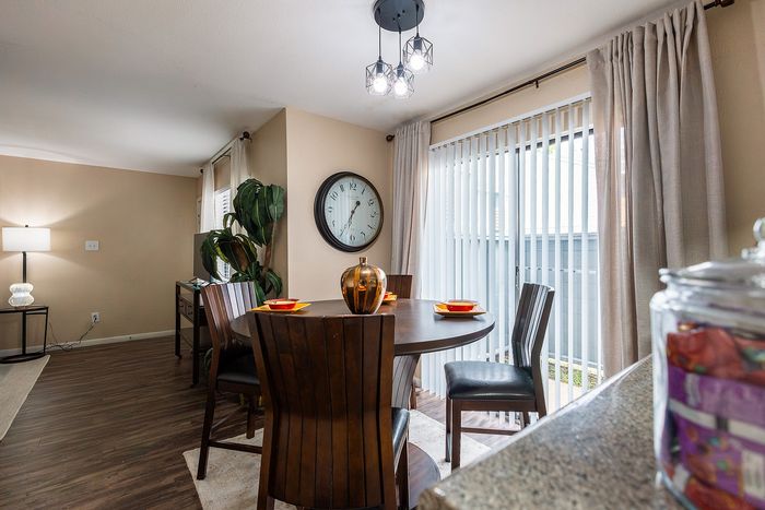 Kitchen with breakfast bar, white cabinetry, and black appliances at Waterchase Apartments in Humble, TX