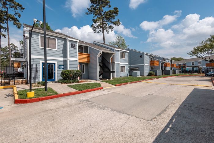 Renovated apartment exterior with modern color scheme at Waterchase Apartments