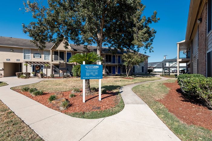 Community entrance signage and walkway at Steeplechase Apartments in Alvin TX