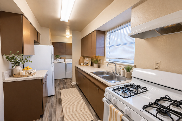 Charming kitchen with natural light, featuring modern appliances, a cozy layout, and elegant wooden cabinetry.
