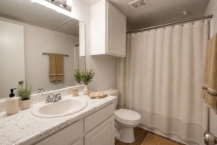 Virtually staged bedroom with ceiling fan and natural light at Green Meadows Apartments