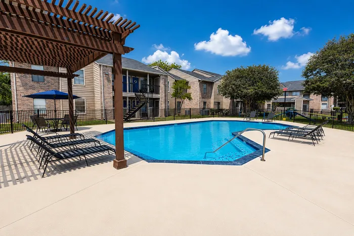 Resort-style swimming pool with Sundeck at Green Meadows Apartments in Houston, TX