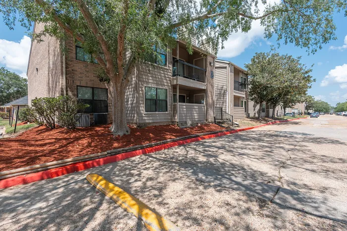Tree-lined apartment community exterior at Green Meadows Apartments in Houston TX