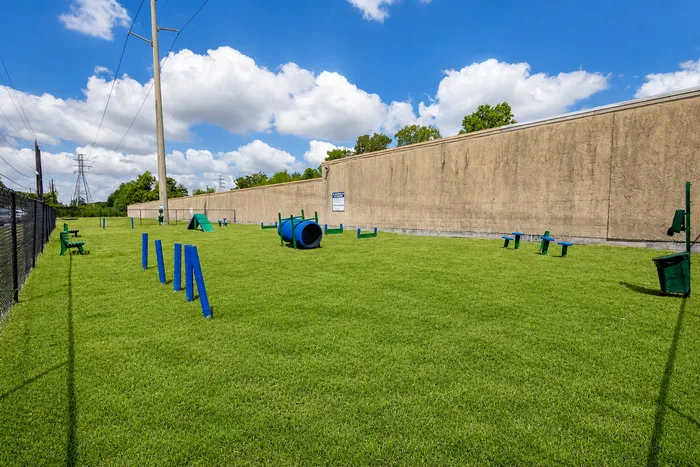 Dog park with agility equipment at Westwood Village Apartments in Rosenberg, TX