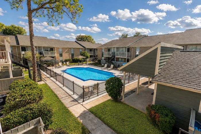 Resort-style pool area with lounge seating at Huntington Oaks