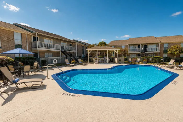 Resort-style pool area with lounge seating at Huntington Oaks