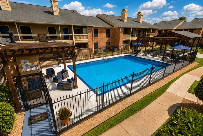Elevated view of the swimming pool and outdoor amenity area at Brookmore Hollow Apartments in Rosenberg, TX.