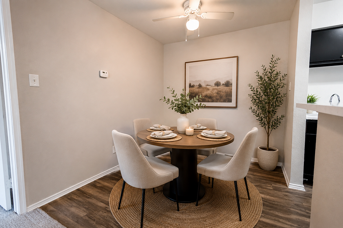 Apartment dining area with modern furnishings adjacent to the kitchen at Brookmore Hollow Apartments.