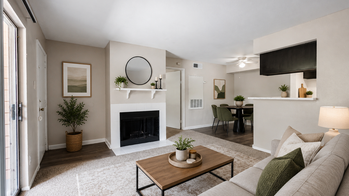 Spacious living room with fireplace, private patio access, and open-concept floor plan at Brookmore Hollow Apartments.