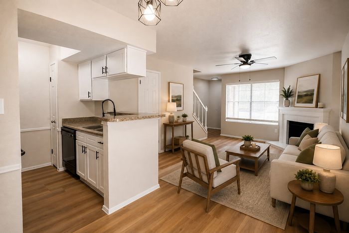Alternate view of the Deerbrook Gardens living room in Humble, TX featuring a fireplace, comfortable seating and open-concept layout.