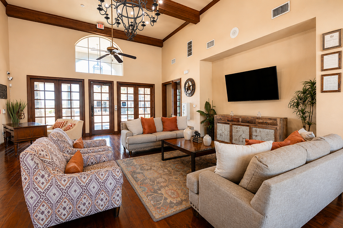 Elegant living room with rich wood accents, plush seating, and a chic chandelier, creating a warm and inviting atmosphere.