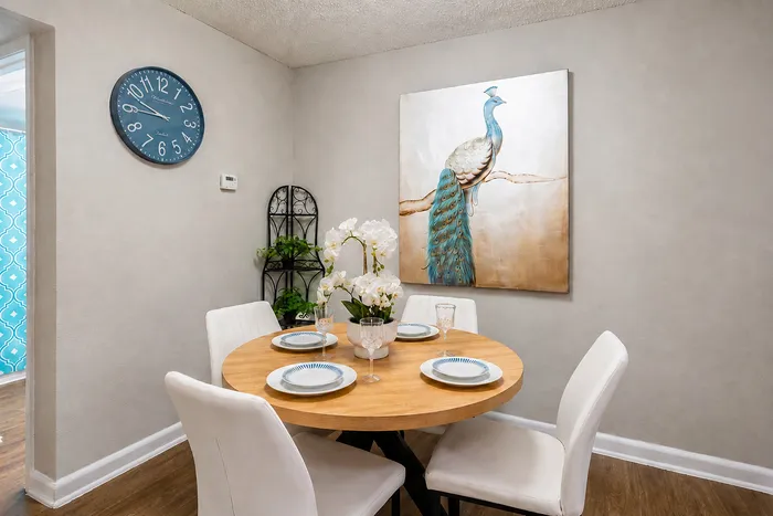 Close view of a furnished dining area with a four-seat table and coordinated decor at The Reserve on Garth apartments in Baytown, TX.