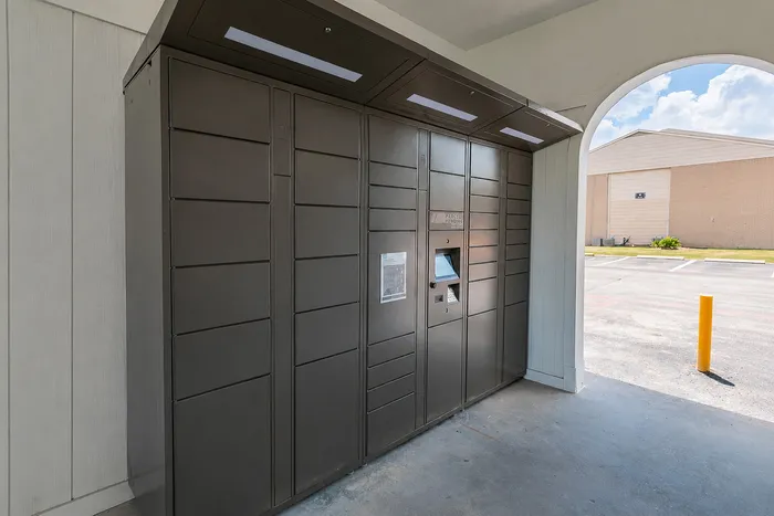 Covered resident package locker station at The Reserve on Garth apartments in Baytown, TX.