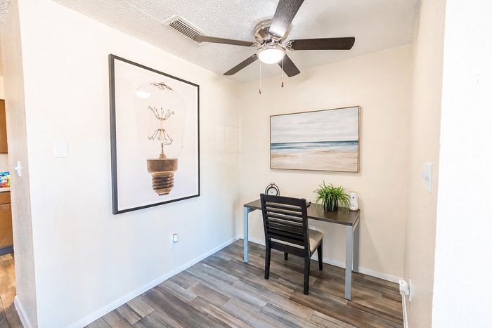 Dedicated home office nook at Apple Creek apartments in Kingsville with desk, chair and wall art.