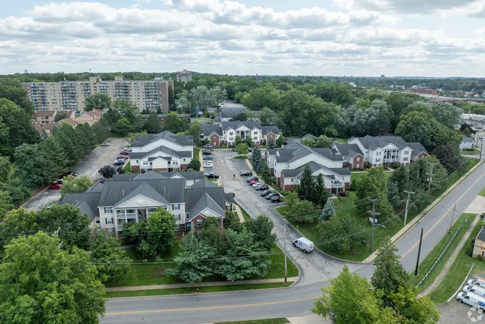 Charming aerial view of a scenic residential complex surrounded by lush greenery and vibrant community living.