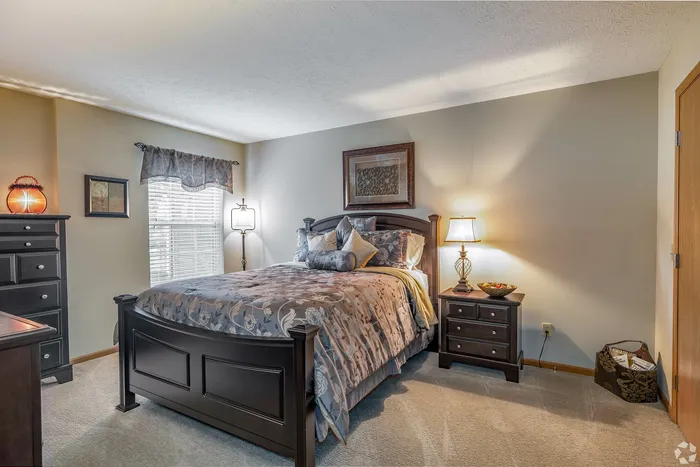 Cozy and inviting bedroom with elegant decor, featuring a plush bed, stylish nightstands, and warm lighting creating a tranquil retreat.