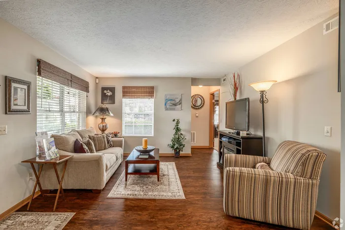 Inviting living room with elegant decor, plush sofa, and warm lighting, ideal for cozy gatherings.