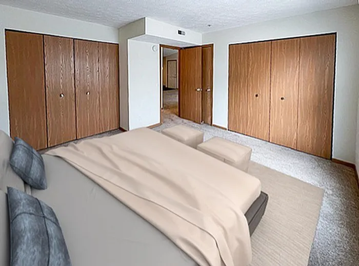 Spacious bedroom featuring a modern bed with soft bedding, ample closet space, and elegant wood accents, perfect for comfort and style.