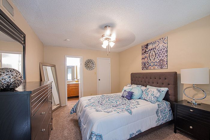 Inviting bedroom with elegant decor, plush bed, and modern furniture, perfect for restful nights.