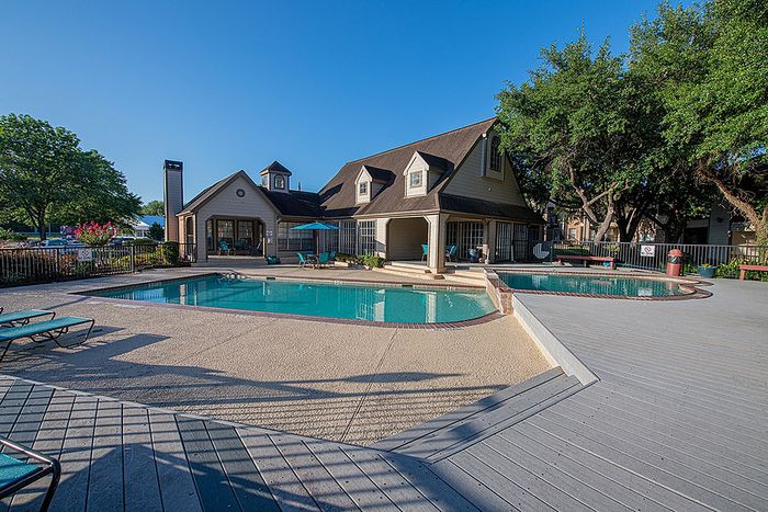 Inviting poolside resort with charming architecture and lush greenery, perfect for relaxation and outdoor enjoyment.