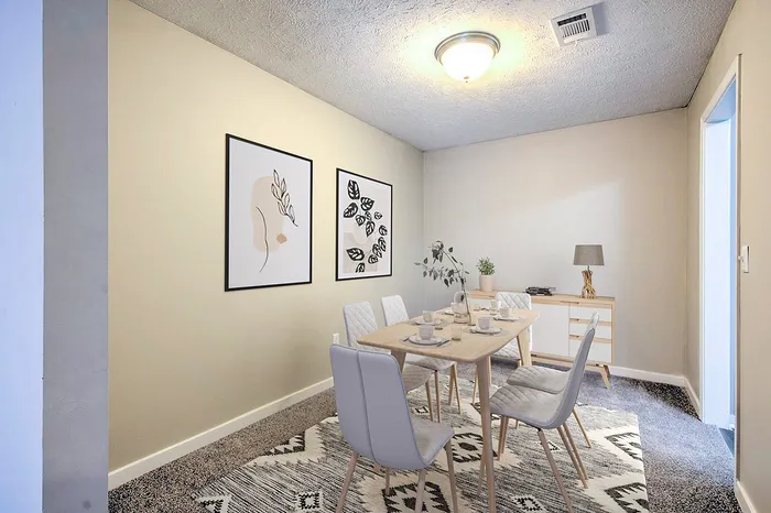 Contemporary dining room with modern artwork, elegant table setting, and stylish decor.