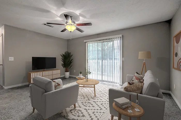 Chic living room with modern gray tones, cozy seating area, and large windows offering abundant natural light.