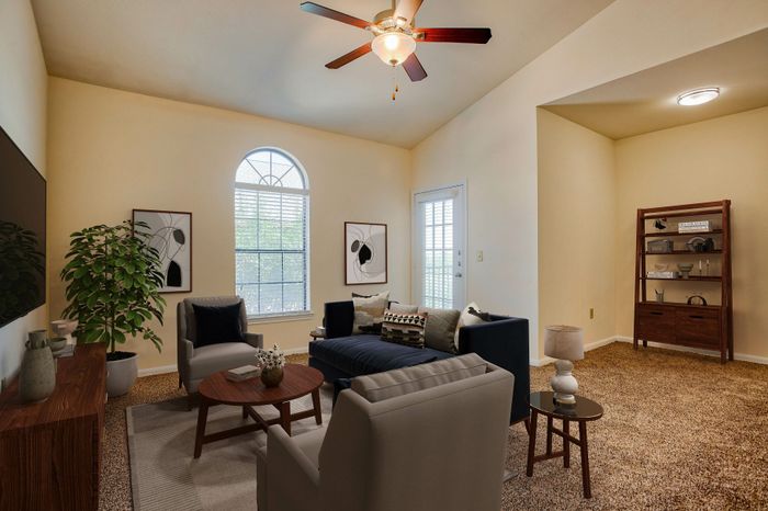 Inviting living room with plush seating, stylish decor, and abundant natural light streaming through large windows.