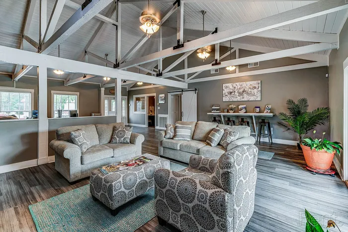 Charming living room boasting vaulted ceilings, cozy seating arrangement, and elegant decor, perfect for relaxation and entertaining.