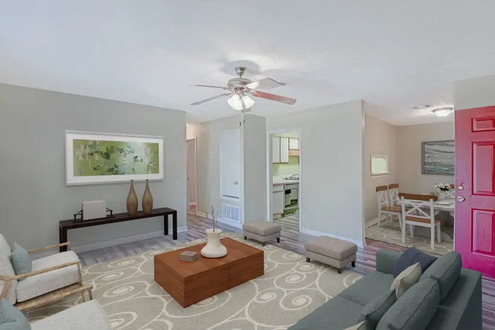 Inviting living room with elegant decor, plush seating, and seamless flow to dining area and kitchen, ideal for entertaining.