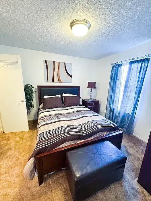 large bedroom with window and bedroom