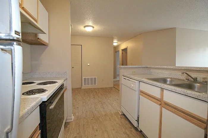 Bright and airy kitchen with modern appliances and sleek countertops, perfect for culinary enthusiasts.