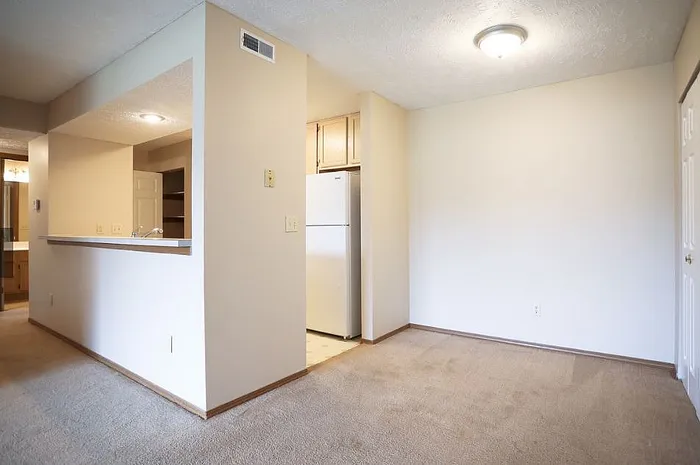 Bright and inviting open-concept kitchen area with modern fixtures and ample lighting, perfect for comfortable living.