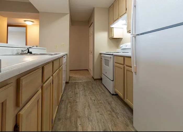 Inviting kitchen with sleek countertops, modern appliances, and warm wood cabinetry, perfect for culinary creativity.