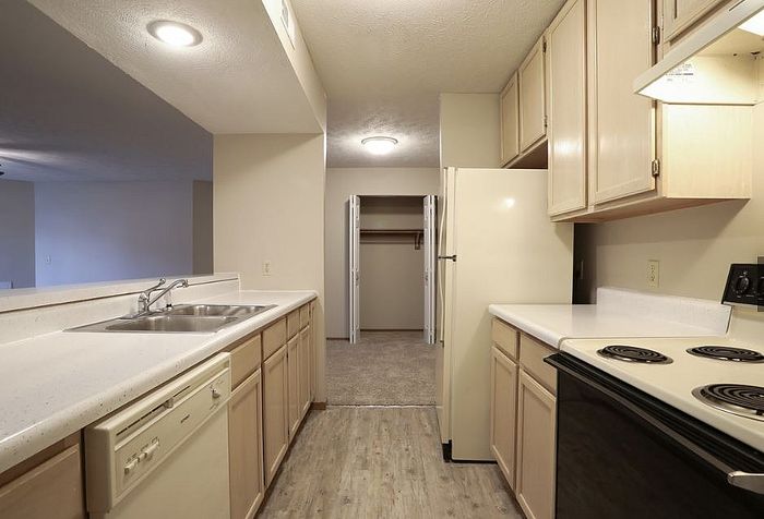 Bright and inviting kitchen with sleek countertops, ample cabinet space, and modern appliances, seamlessly connected to the spacious living area.