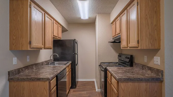 Warm and inviting kitchen boasting rich wood cabinets, sleek countertops, and modern appliances, perfect for culinary adventures.