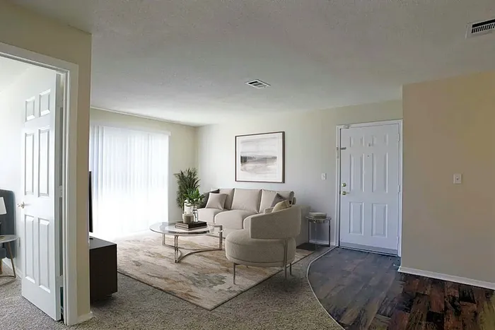 Bright and inviting living room featuring modern furniture, large windows with sheer curtains, soft carpet underfoot, and a welcoming atmosphere perfect for relaxation.