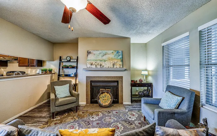 Cozy living room with elegant fireplace, modern decor, and abundant natural light, showcasing a blend of comfort and style.